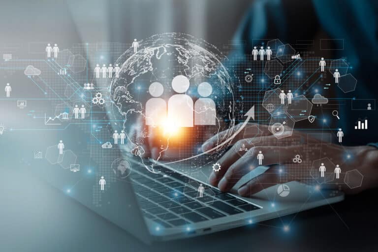 Hands typing on a laptop with digital icons, representing "What is Enterprise Service Management."